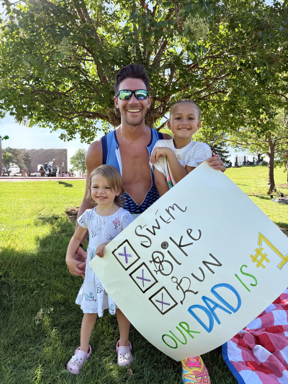 Dr. Lane in a triathlon having a photo taken with his family